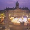 High angle view of a town square lit up at dusk Dam Square Amsterdam Netherlands Poster Print by - 36 x 12