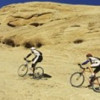 Panoramic Images Side profile of two men mountain bilking on rocks Slickrock Trail Moab Utah USA Poster Print by Panoramic Images - 36 x 12